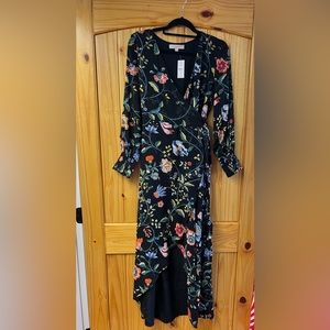 Long sleeve patterned dress with asymmetrical hem.